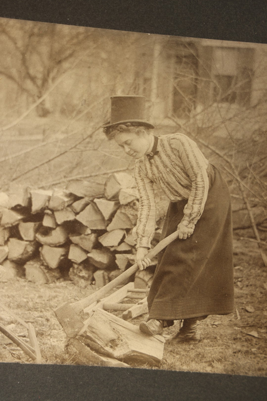 Antique Board-Mounted Photograph of a Woman Chopping Firewood, Inscribed "Mike" on Verso, Dated March 15, 1902