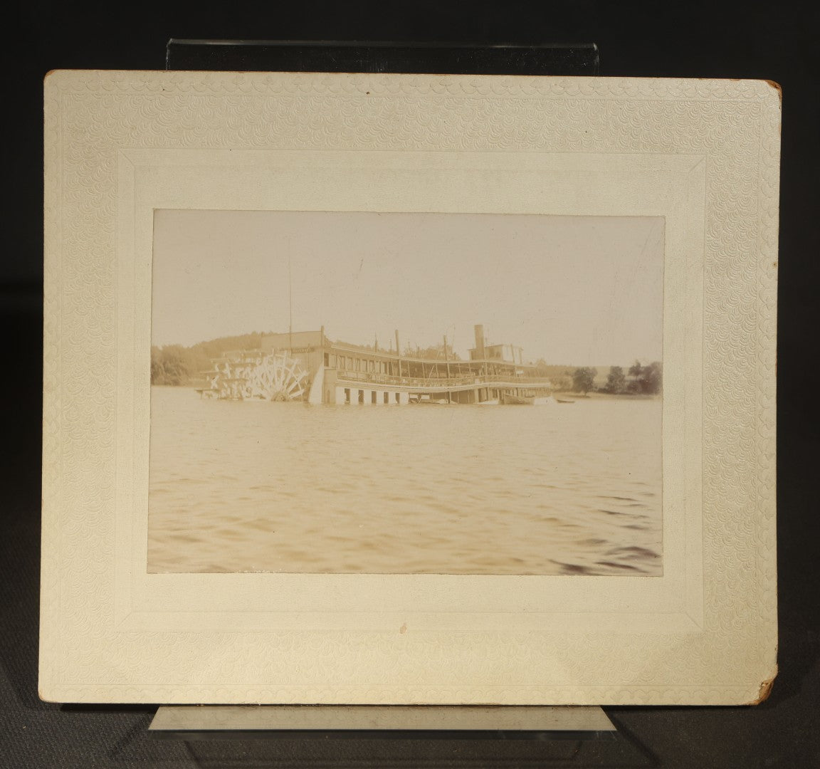 Grouping of Five Antique Board-Mounted Photographs including Sunken Paddle Wheel Steamboat Inscribed "Sunk on Currier Rock 1903," German Christmas Pyramid, and Child with Taxidermy Bird by Nicholas, Bristol, New Hampshire