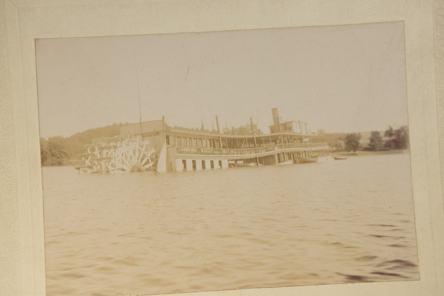 Grouping of Five Antique Board-Mounted Photographs including Sunken Paddle Wheel Steamboat Inscribed "Sunk on Currier Rock 1903," German Christmas Pyramid, and Child with Taxidermy Bird by Nicholas, Bristol, New Hampshire