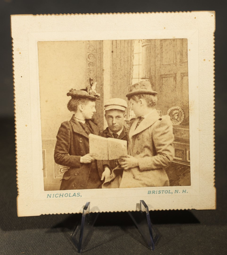 Grouping of Five Antique Board-Mounted Photographs including Sunken Paddle Wheel Steamboat Inscribed "Sunk on Currier Rock 1903," German Christmas Pyramid, and Child with Taxidermy Bird by Nicholas, Bristol, New Hampshire