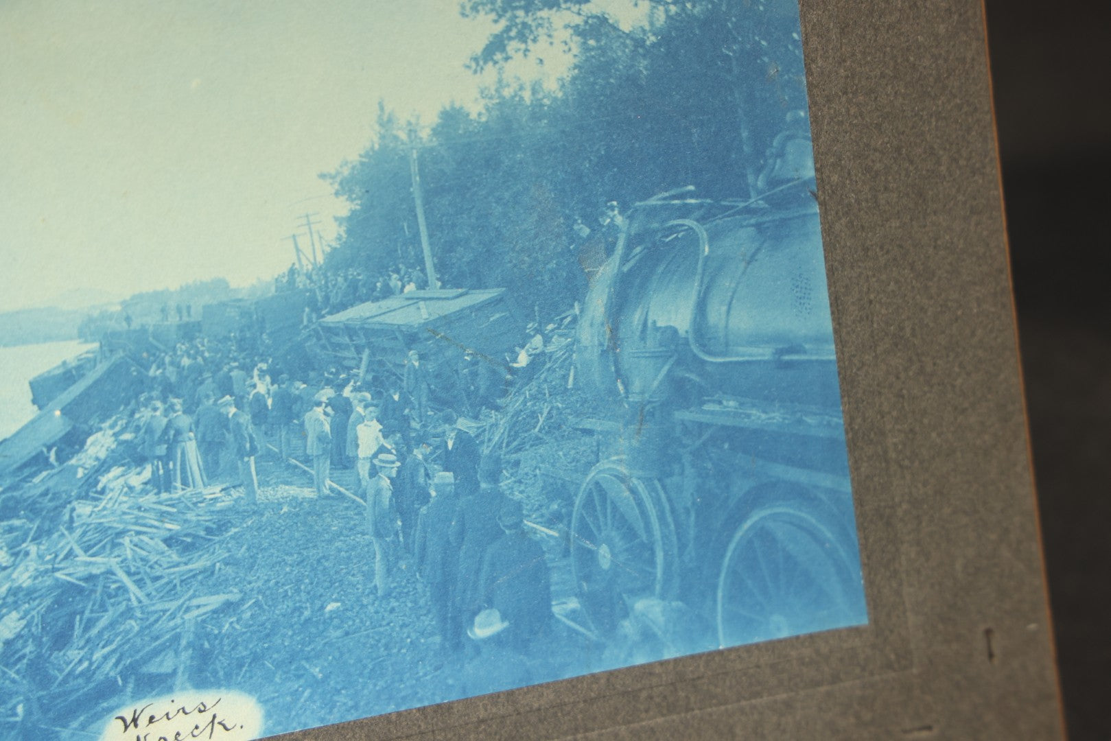 Grouping of 12 Antique Cyanotype Photographs including "Weirs Wreck" Train Derailment, Occupational Newspaper Deliveryman with "The Sun" Cart, Naval Warships, Cyanotype on Birch Bark, Man with Bicycle, and Photo Gallery Interior