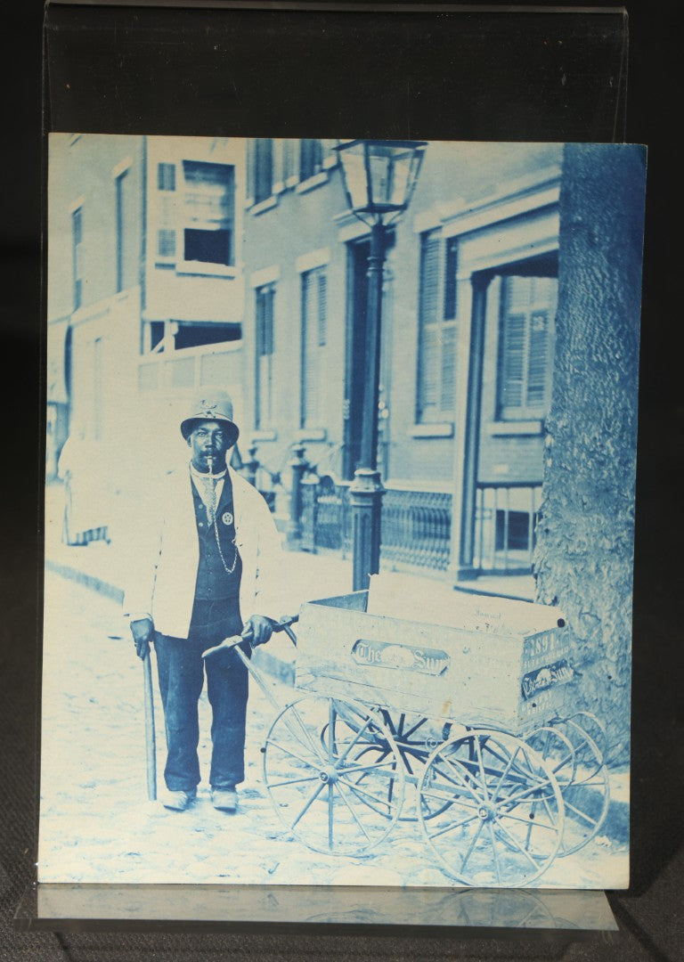 Grouping of 12 Antique Cyanotype Photographs including "Weirs Wreck" Train Derailment, Occupational Newspaper Deliveryman with "The Sun" Cart, Naval Warships, Cyanotype on Birch Bark, Man with Bicycle, and Photo Gallery Interior