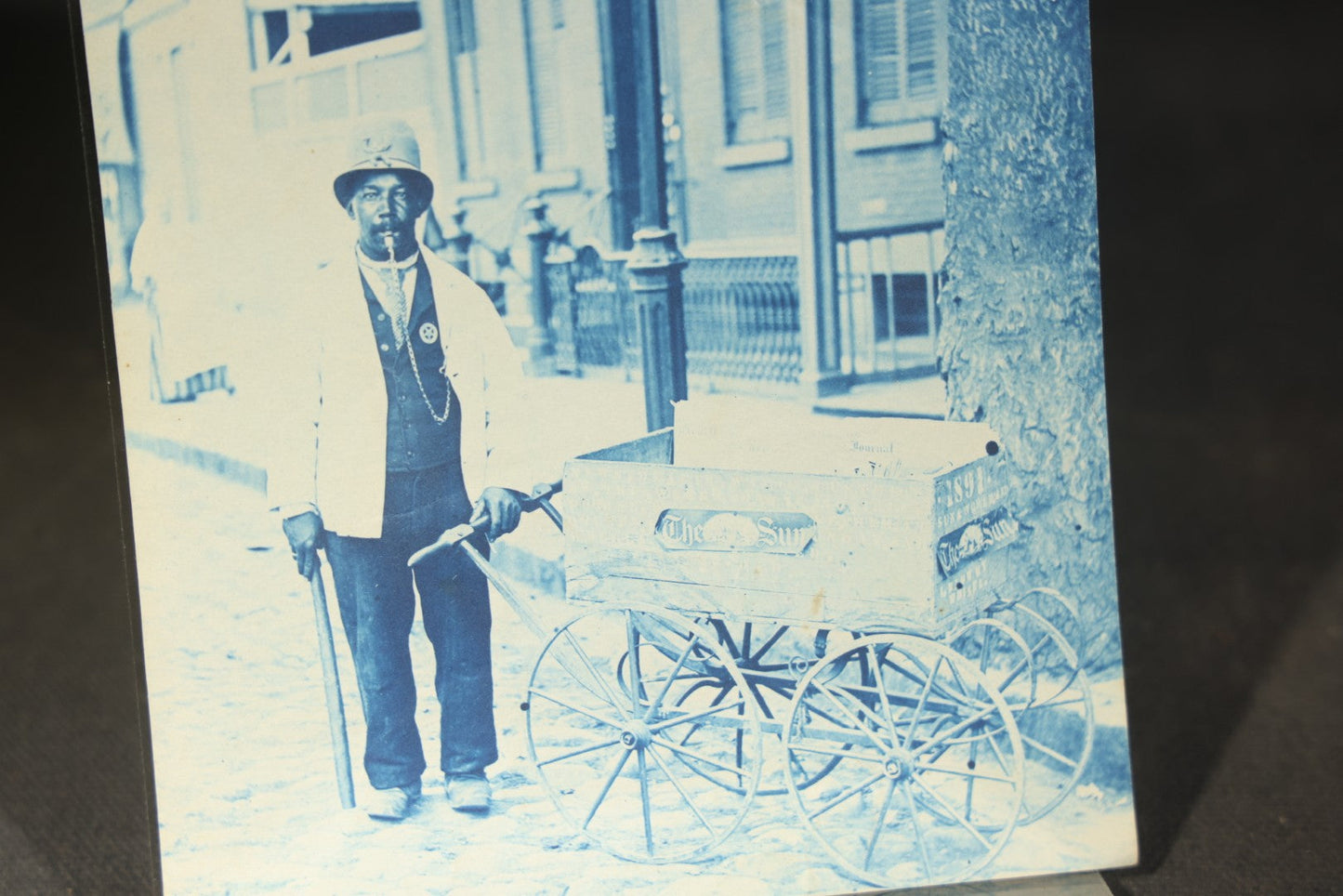 Grouping of 12 Antique Cyanotype Photographs including "Weirs Wreck" Train Derailment, Occupational Newspaper Deliveryman with "The Sun" Cart, Naval Warships, Cyanotype on Birch Bark, Man with Bicycle, and Photo Gallery Interior