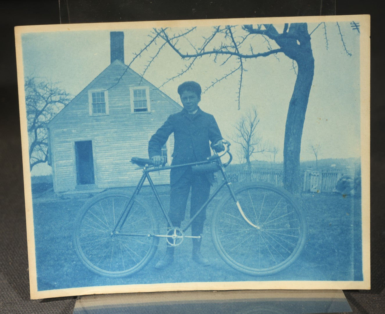 Grouping of 12 Antique Cyanotype Photographs including "Weirs Wreck" Train Derailment, Occupational Newspaper Deliveryman with "The Sun" Cart, Naval Warships, Cyanotype on Birch Bark, Man with Bicycle, and Photo Gallery Interior