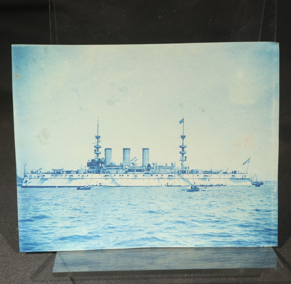 Grouping of 12 Antique Cyanotype Photographs including "Weirs Wreck" Train Derailment, Occupational Newspaper Deliveryman with "The Sun" Cart, Naval Warships, Cyanotype on Birch Bark, Man with Bicycle, and Photo Gallery Interior