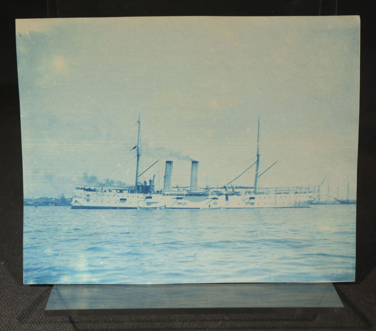 Grouping of 12 Antique Cyanotype Photographs including "Weirs Wreck" Train Derailment, Occupational Newspaper Deliveryman with "The Sun" Cart, Naval Warships, Cyanotype on Birch Bark, Man with Bicycle, and Photo Gallery Interior
