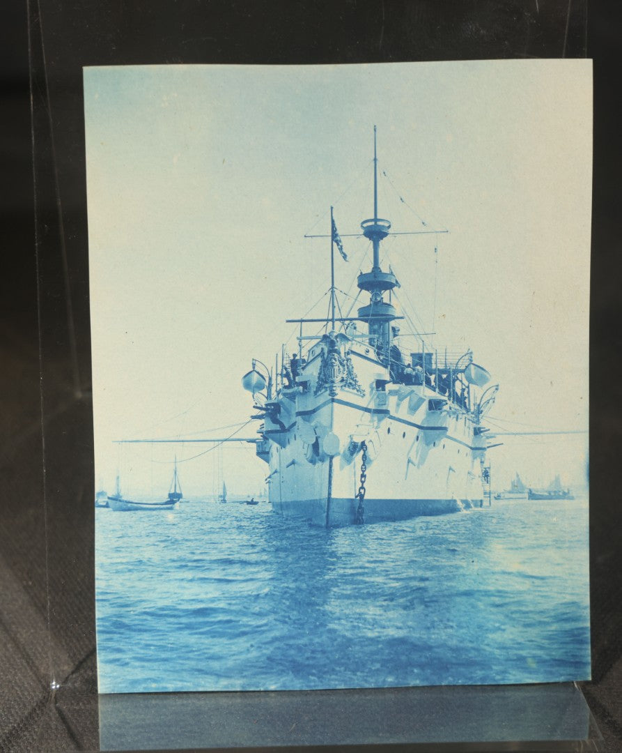 Grouping of 12 Antique Cyanotype Photographs including "Weirs Wreck" Train Derailment, Occupational Newspaper Deliveryman with "The Sun" Cart, Naval Warships, Cyanotype on Birch Bark, Man with Bicycle, and Photo Gallery Interior