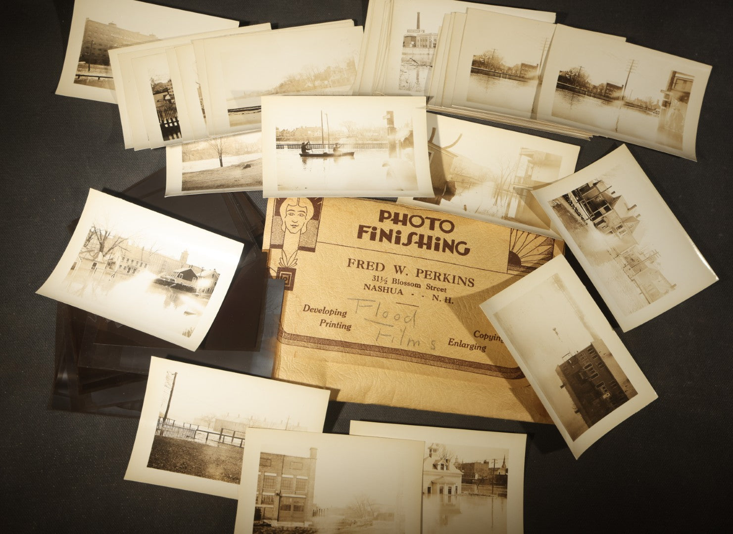 Vintage Grouping of Approximately 40 Snapshot Photographs and Negatives Documenting a Flood in Nashua, New Hampshire, in Fred W. Perkins Photo Finishing Envelope Marked "Flood Films"