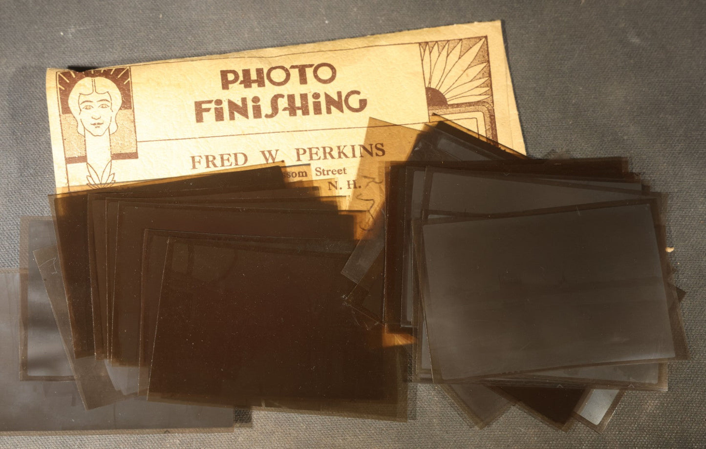 Vintage Grouping of Approximately 40 Snapshot Photographs and Negatives Documenting a Flood in Nashua, New Hampshire, in Fred W. Perkins Photo Finishing Envelope Marked "Flood Films"