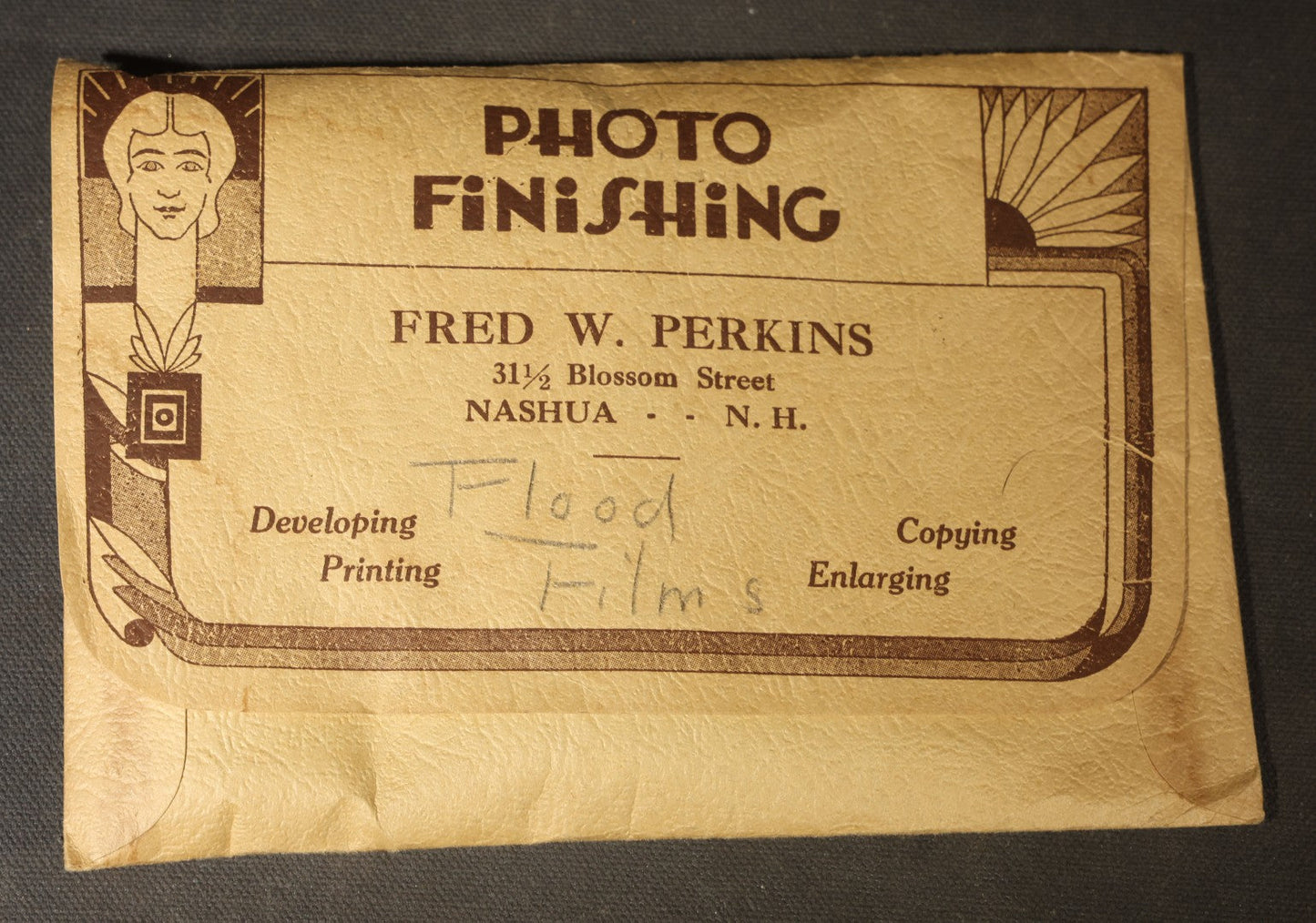 Vintage Grouping of Approximately 40 Snapshot Photographs and Negatives Documenting a Flood in Nashua, New Hampshire, in Fred W. Perkins Photo Finishing Envelope Marked "Flood Films"