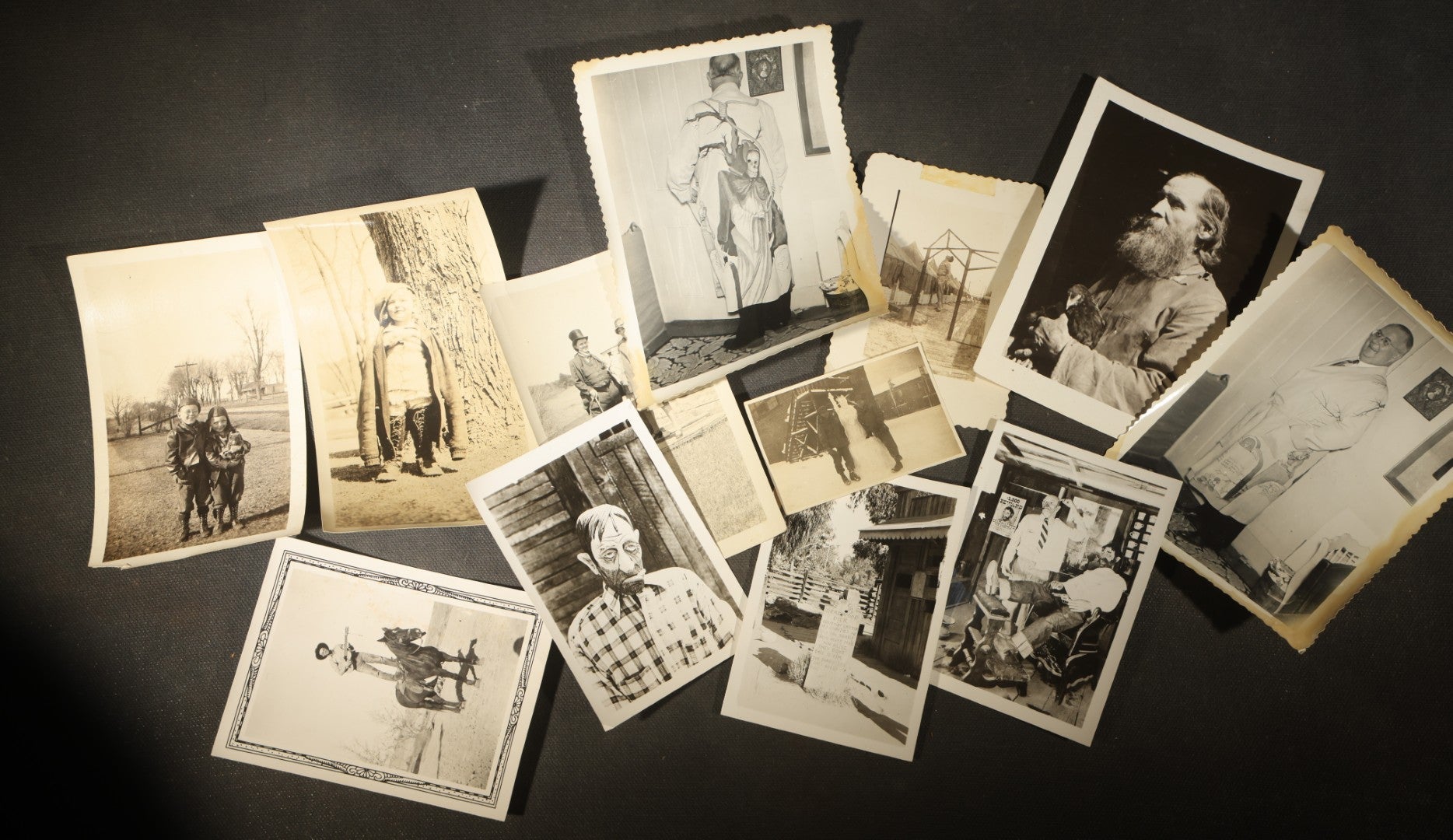Grouping of 14 Vintage Snapshot Photographs of Costumes, Masks, and Oddities including Grim Reaper Painted Smock, Barber Shop Gag Scene, and Camp Blanding Military Stunt