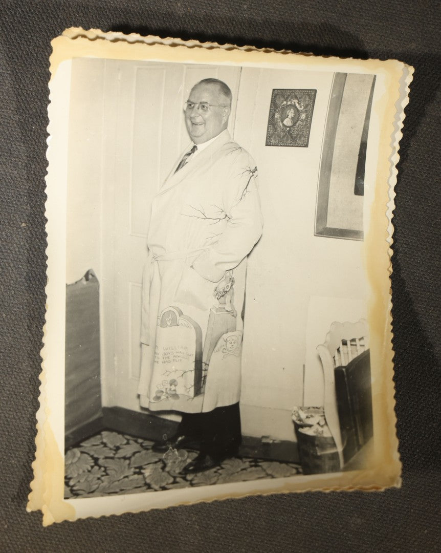 Grouping of 14 Vintage Snapshot Photographs of Costumes, Masks, and Oddities including Grim Reaper Painted Smock, Barber Shop Gag Scene, and Camp Blanding Military Stunt