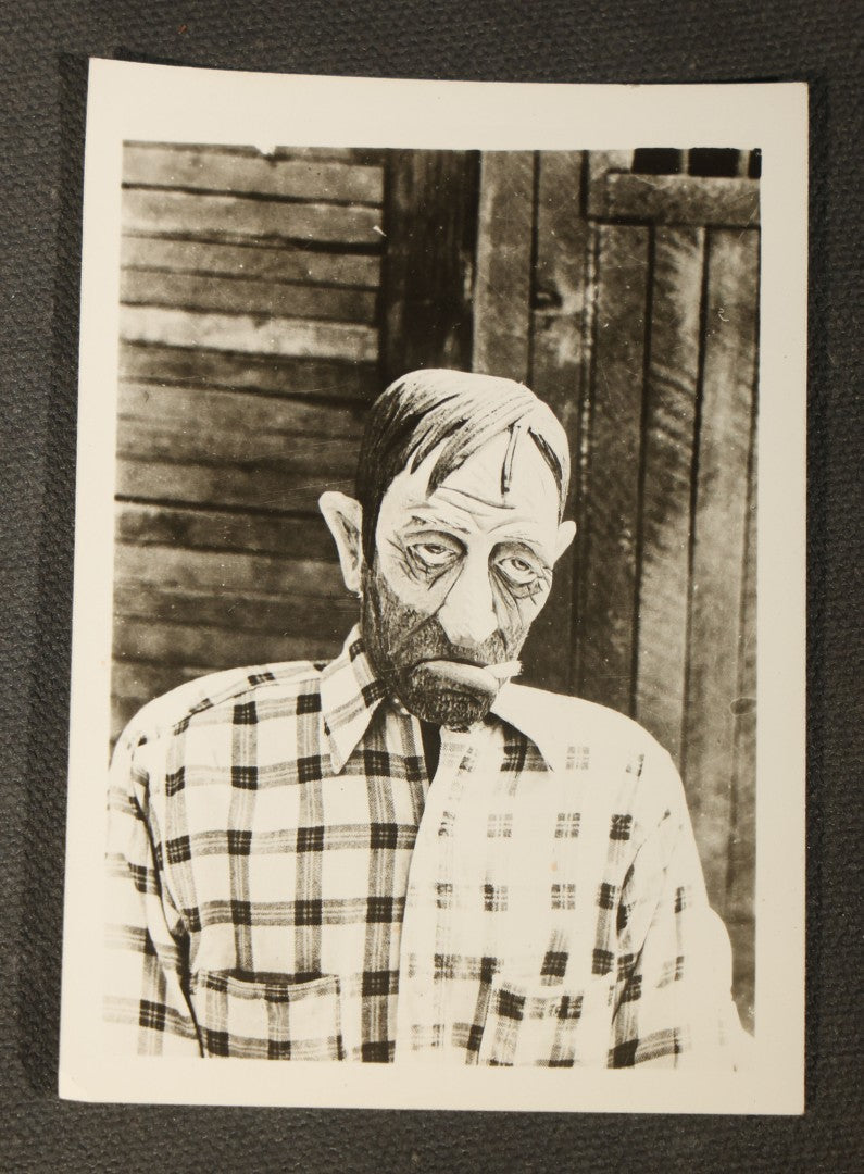 Grouping of 14 Vintage Snapshot Photographs of Costumes, Masks, and Oddities including Grim Reaper Painted Smock, Barber Shop Gag Scene, and Camp Blanding Military Stunt
