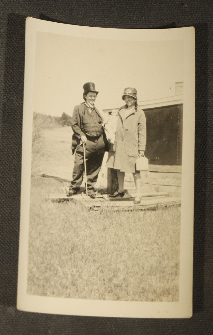 Grouping of 14 Vintage Snapshot Photographs of Costumes, Masks, and Oddities including Grim Reaper Painted Smock, Barber Shop Gag Scene, and Camp Blanding Military Stunt