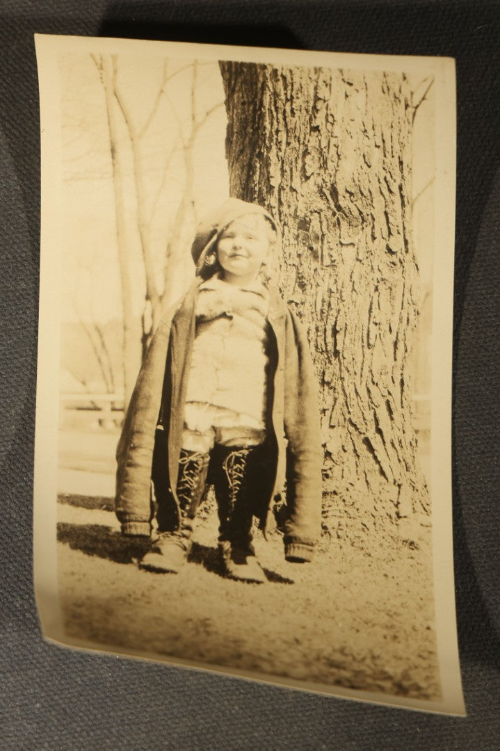 Grouping of 14 Vintage Snapshot Photographs of Costumes, Masks, and Oddities including Grim Reaper Painted Smock, Barber Shop Gag Scene, and Camp Blanding Military Stunt