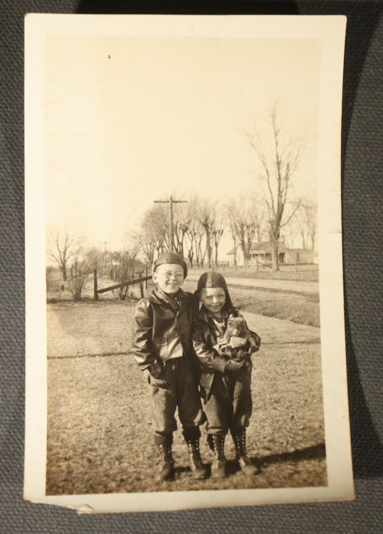 Grouping of 14 Vintage Snapshot Photographs of Costumes, Masks, and Oddities including Grim Reaper Painted Smock, Barber Shop Gag Scene, and Camp Blanding Military Stunt