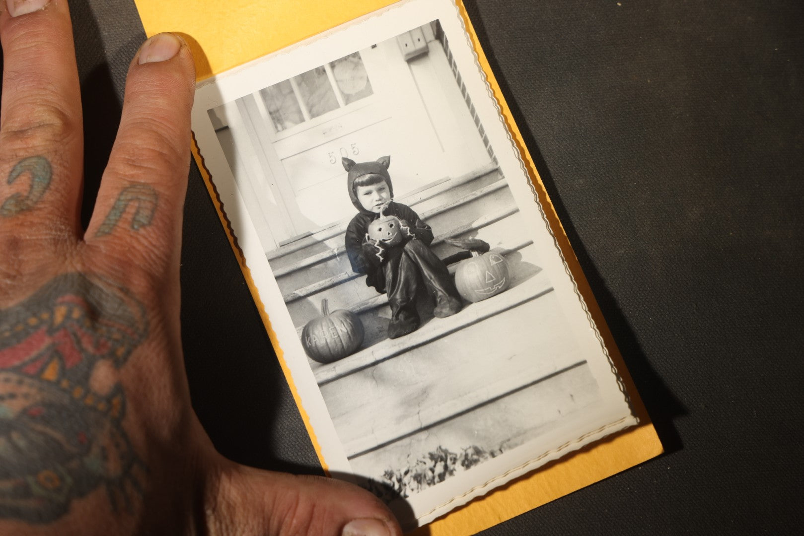 Vintage Halloween Snapshot Photo Album of a Child in Black Cat Costume with Jack-O-Lanterns and Carved Pumpkins, October 1952, Woodman Photo