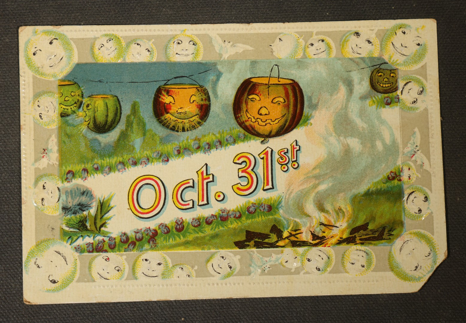 Antique Halloween Postcard with Jack-O-Lantern Lanterns, Bonfire, and Embossed Moon Face Border, "Oct. 31st," No. 1028, Printed in Saxony, Postmarked 1911, Swampscott, Massachusetts