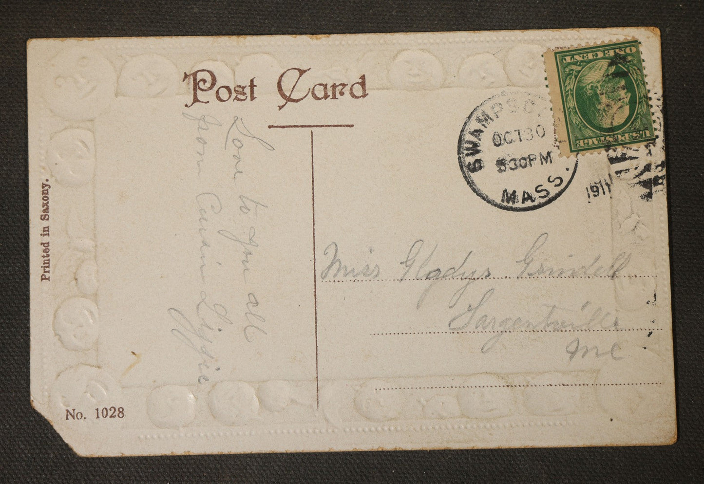 Antique Halloween Postcard with Jack-O-Lantern Lanterns, Bonfire, and Embossed Moon Face Border, "Oct. 31st," No. 1028, Printed in Saxony, Postmarked 1911, Swampscott, Massachusetts