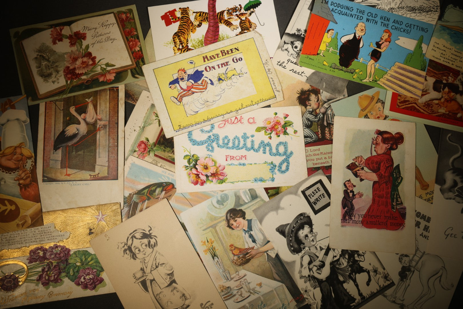Grouping of approximately 25 Antique and Vintage Postcards including Comic, Greeting, Floral, and Holiday Subjects