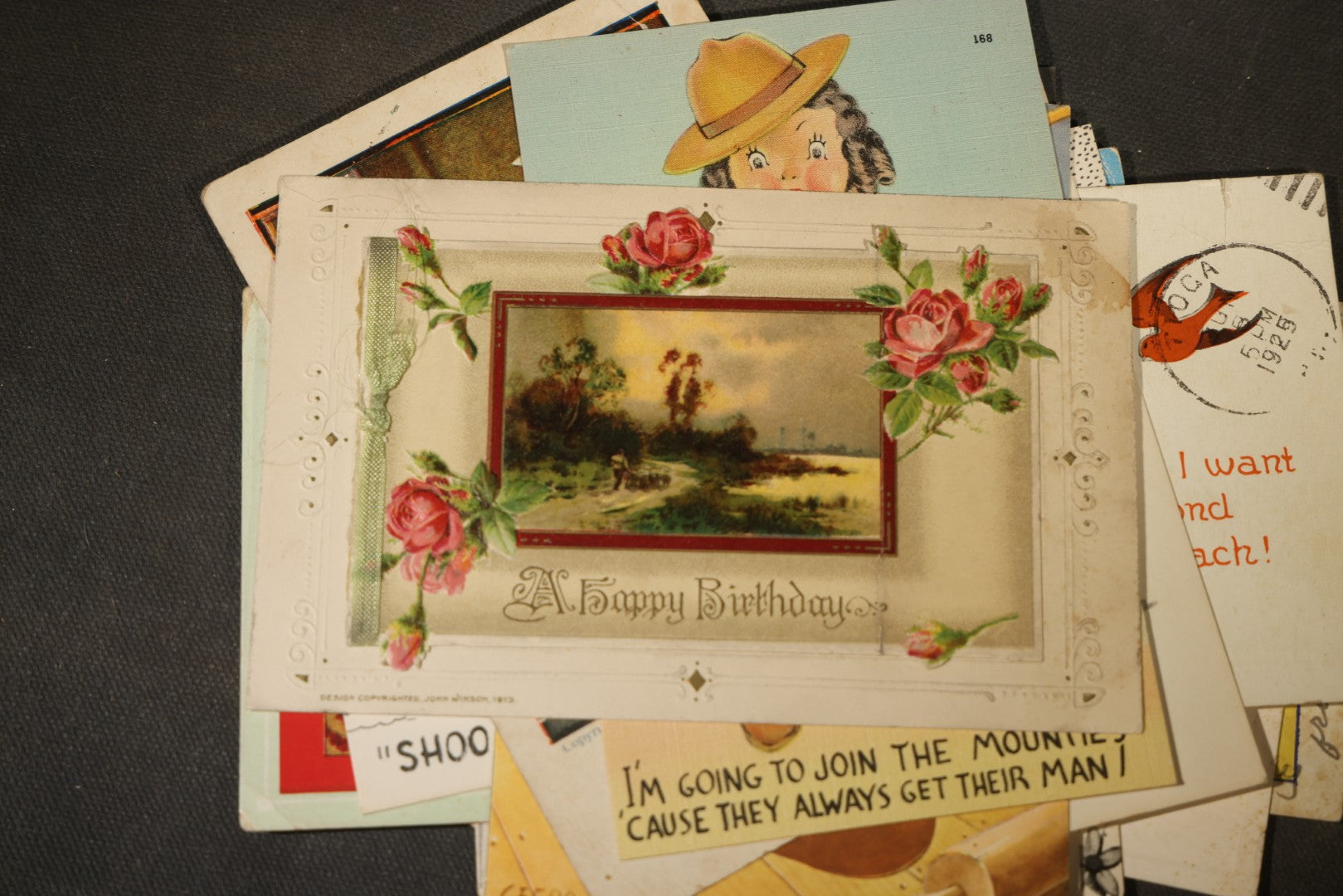 Grouping of approximately 25 Antique and Vintage Postcards including Comic, Greeting, Floral, and Holiday Subjects