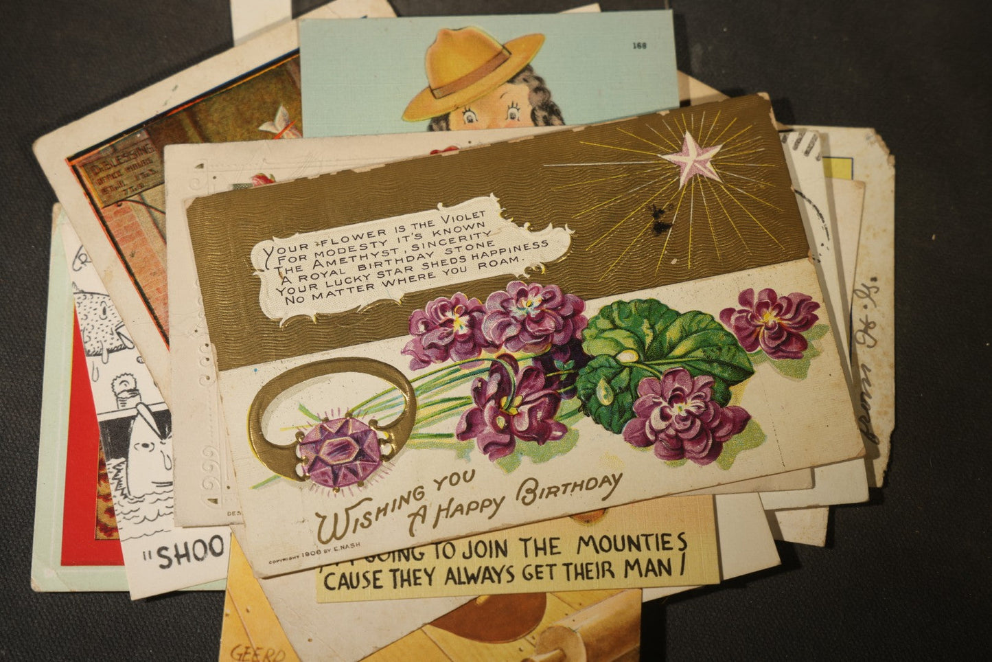 Grouping of approximately 25 Antique and Vintage Postcards including Comic, Greeting, Floral, and Holiday Subjects