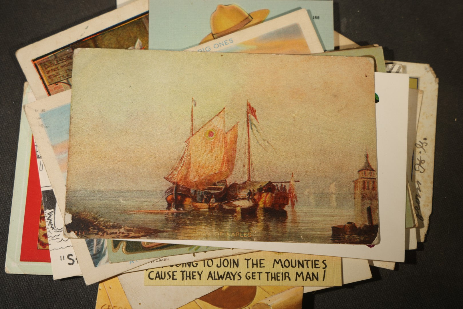 Grouping of approximately 25 Antique and Vintage Postcards including Comic, Greeting, Floral, and Holiday Subjects