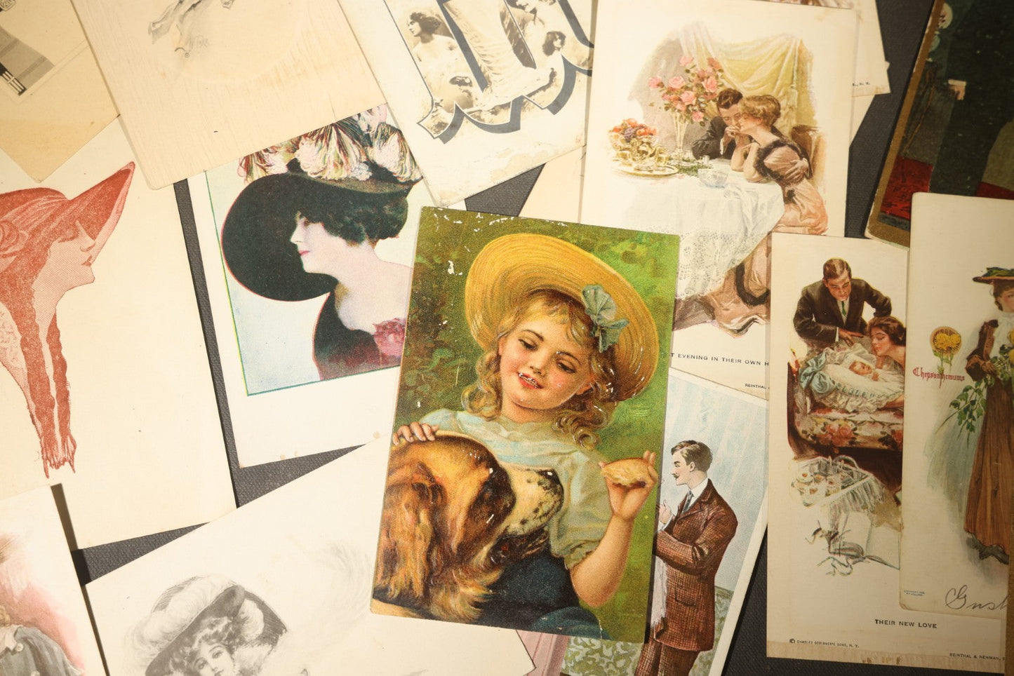 Grouping of approximately 15 Antique and Vintage Postcards including Girl with Dog, Romantic Couples, and Women's Portraits
