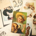 Lot 127 - Grouping of Approximately 15 Antique and Vintage Postcards Including Girl with Dog, Romantic Couples, and Women's Portraits