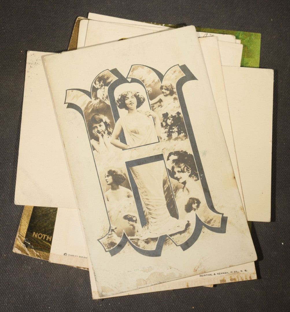 Grouping of approximately 15 Antique and Vintage Postcards including Girl with Dog, Romantic Couples, and Women's Portraits