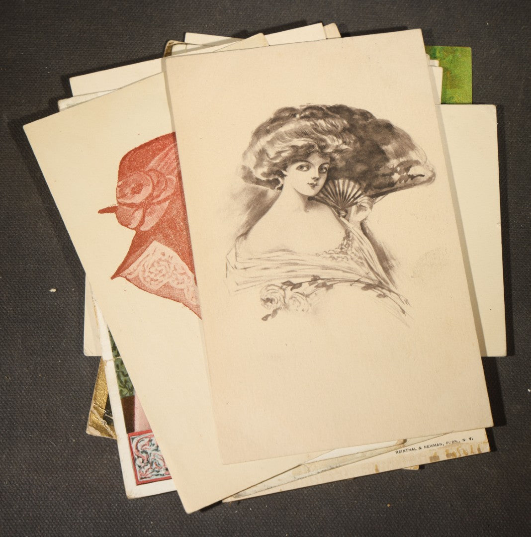Grouping of approximately 15 Antique and Vintage Postcards including Girl with Dog, Romantic Couples, and Women's Portraits