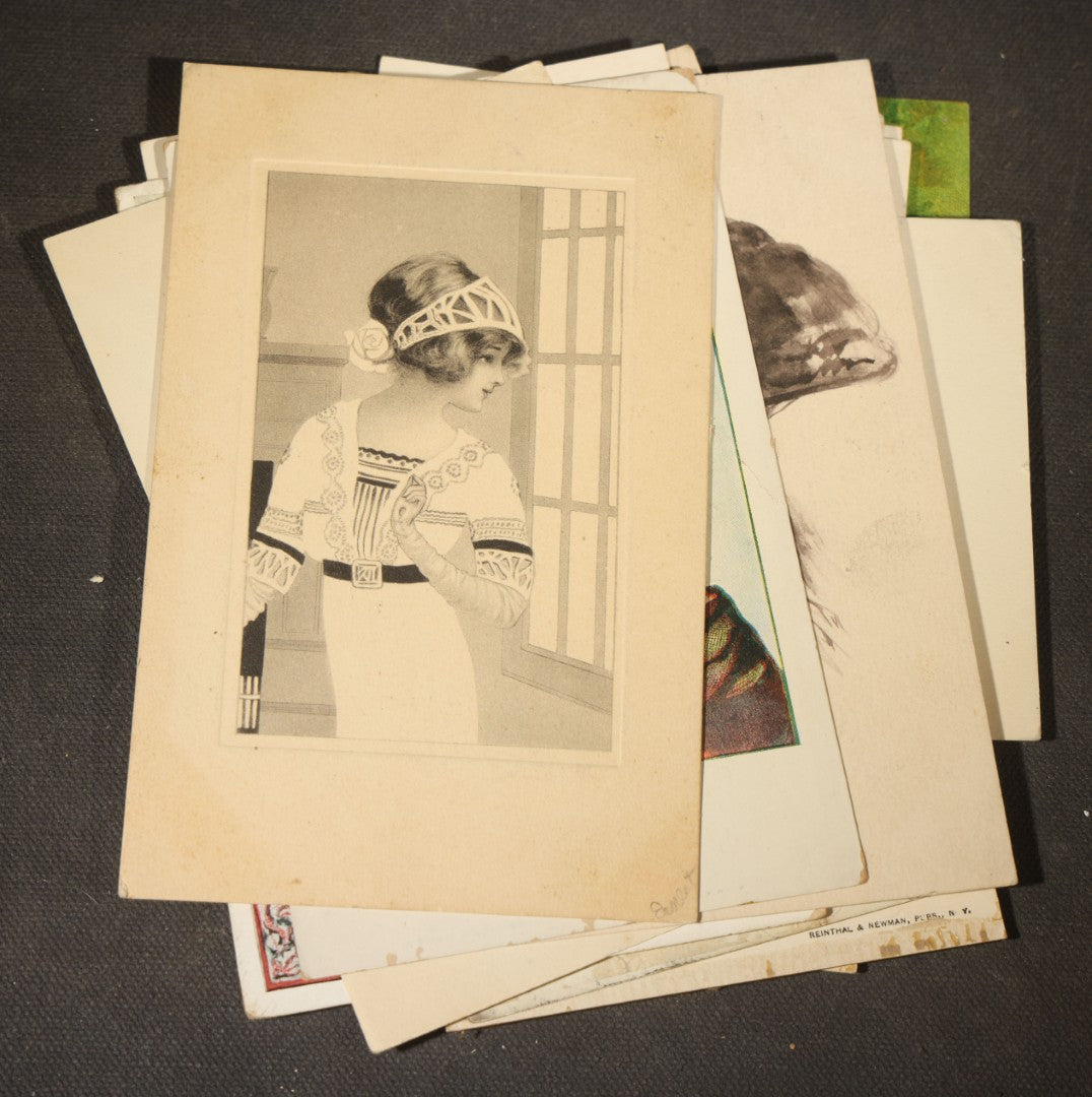 Grouping of approximately 15 Antique and Vintage Postcards including Girl with Dog, Romantic Couples, and Women's Portraits