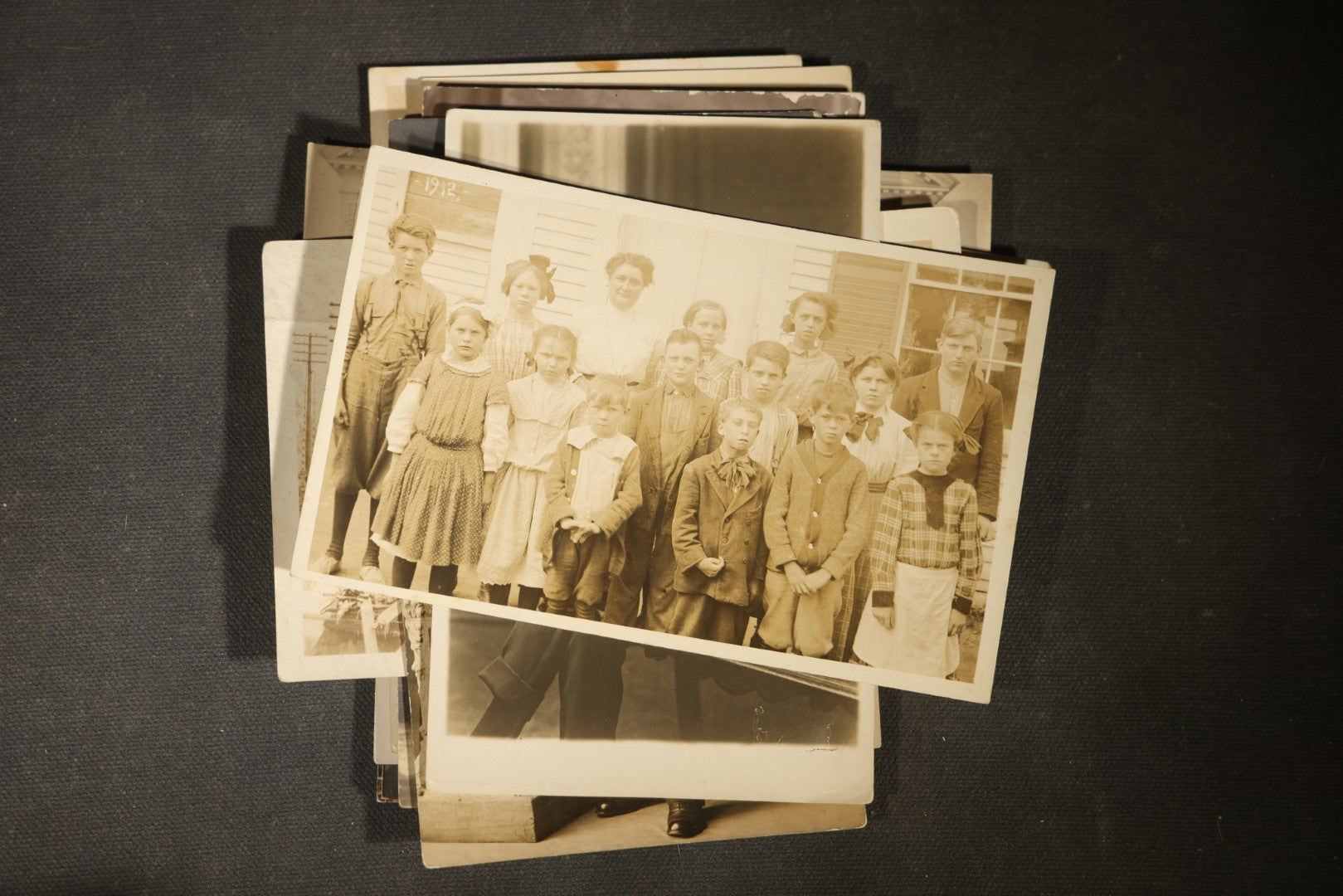Grouping of approximately 40 Antique Real Photo Postcards R.P.P.C. including Military Soldier Portrait, Ocean Liner, Marching Band, and Portraits