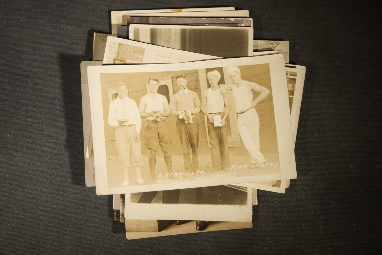 Grouping of approximately 40 Antique Real Photo Postcards R.P.P.C. including Military Soldier Portrait, Ocean Liner, Marching Band, and Portraits