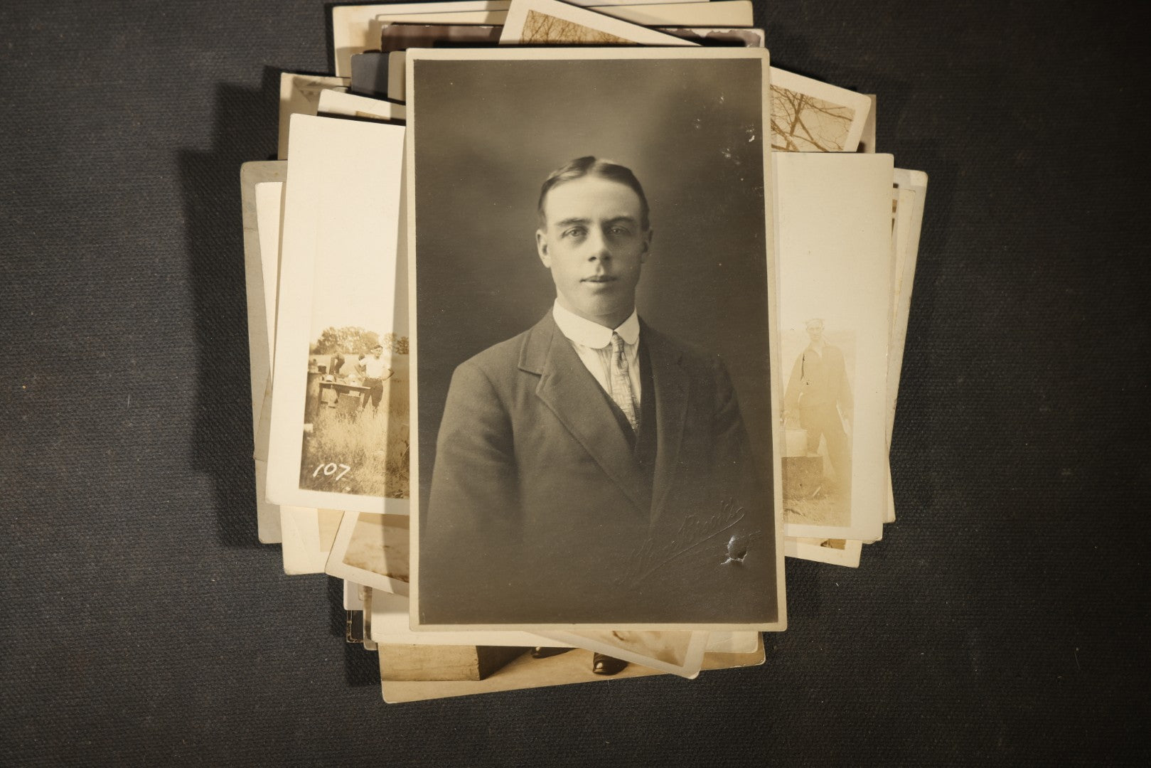 Grouping of approximately 40 Antique Real Photo Postcards R.P.P.C. including Military Soldier Portrait, Ocean Liner, Marching Band, and Portraits