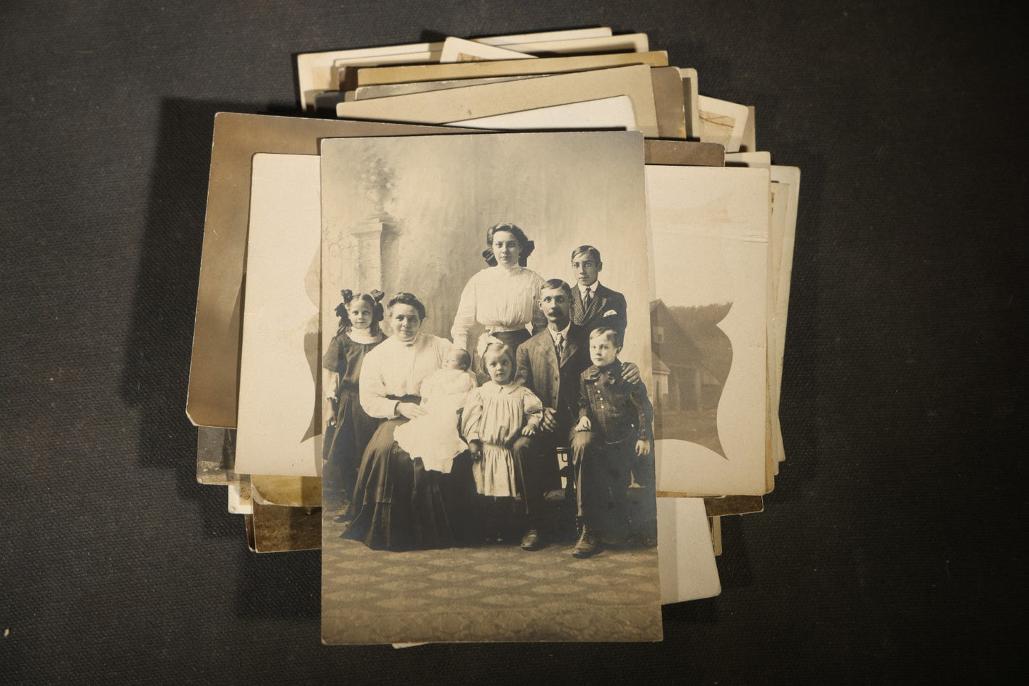 Grouping of approximately 40 Antique Real Photo Postcards R.P.P.C. including Military Soldier Portrait, Ocean Liner, Marching Band, and Portraits