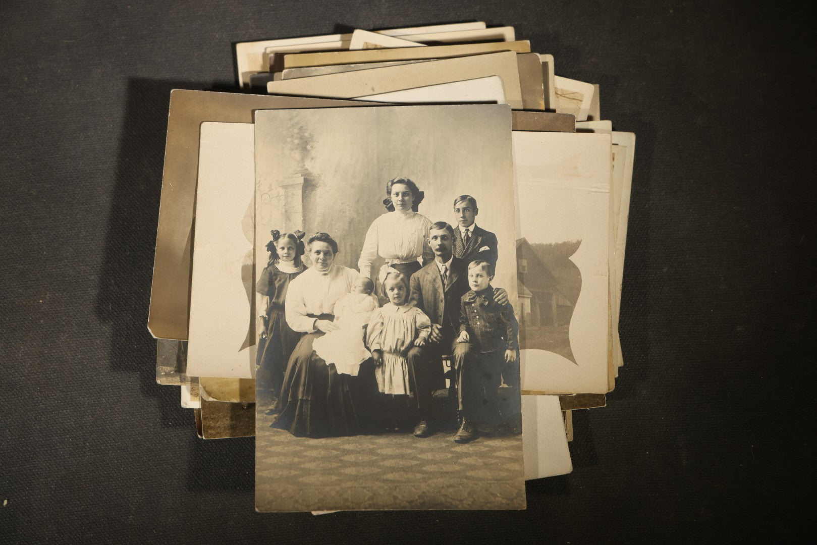 Grouping of approximately 40 Antique Real Photo Postcards R.P.P.C. including Military Soldier Portrait, Ocean Liner, Marching Band, and Portraits
