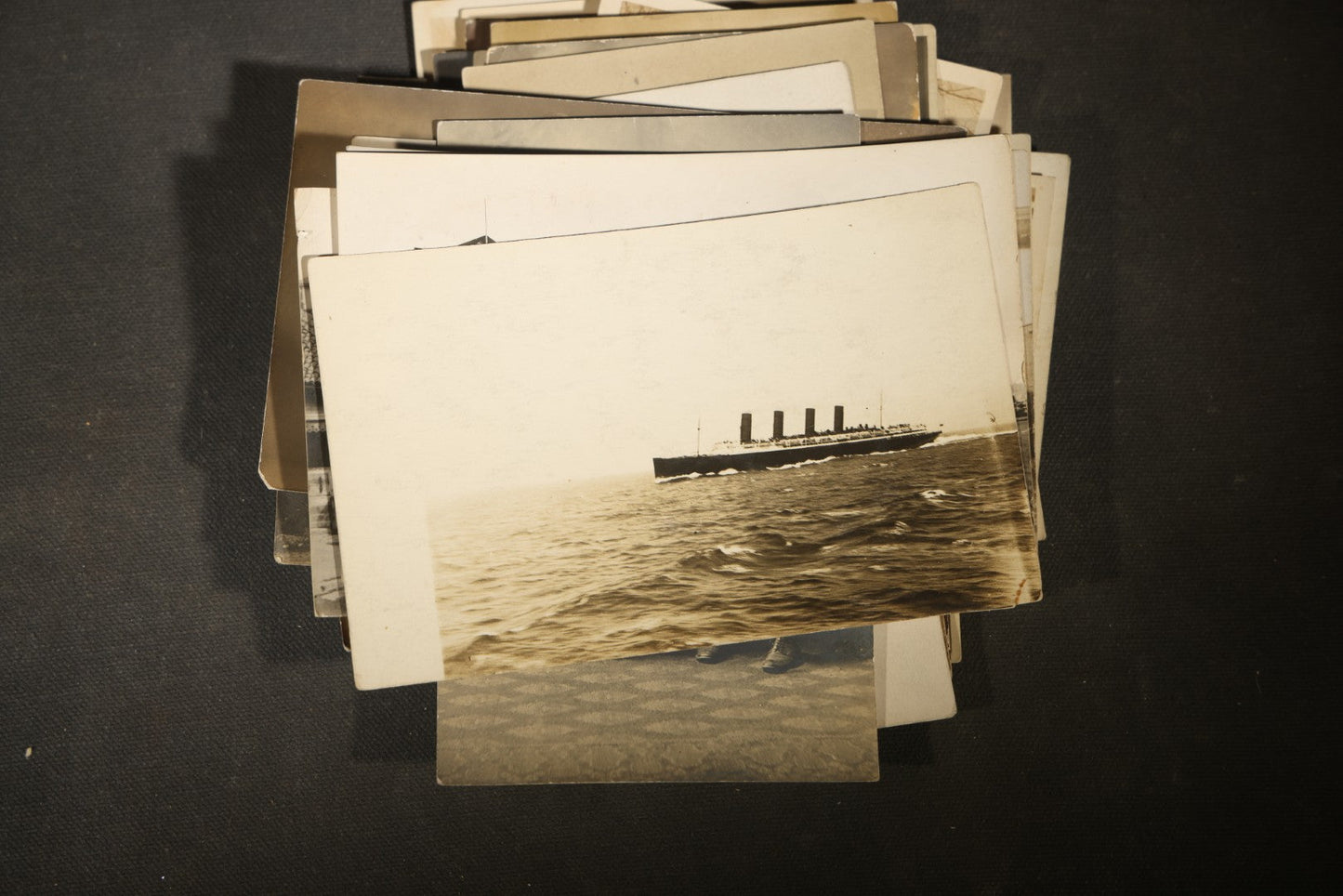 Grouping of approximately 40 Antique Real Photo Postcards R.P.P.C. including Military Soldier Portrait, Ocean Liner, Marching Band, and Portraits