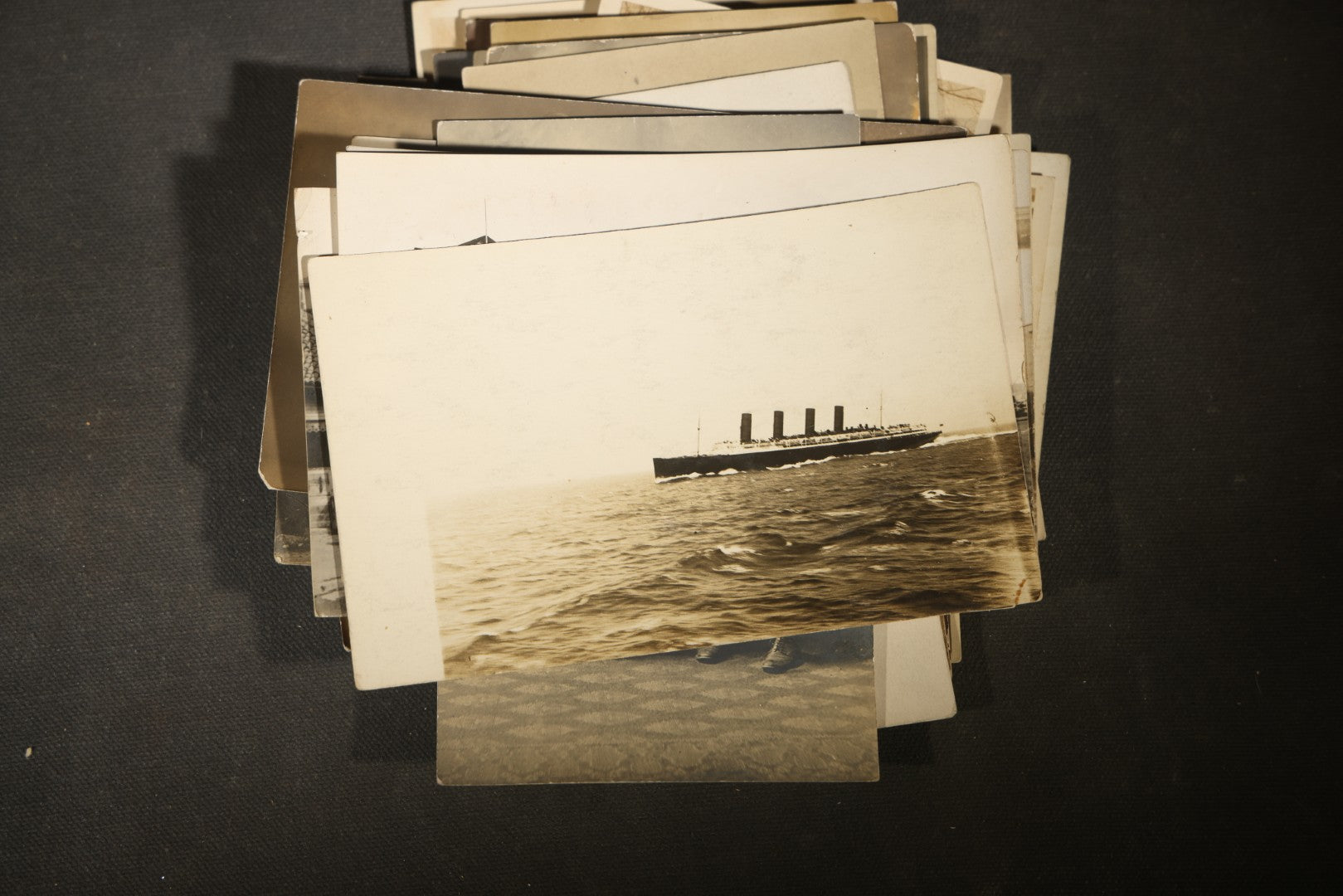Grouping of approximately 40 Antique Real Photo Postcards R.P.P.C. including Military Soldier Portrait, Ocean Liner, Marching Band, and Portraits