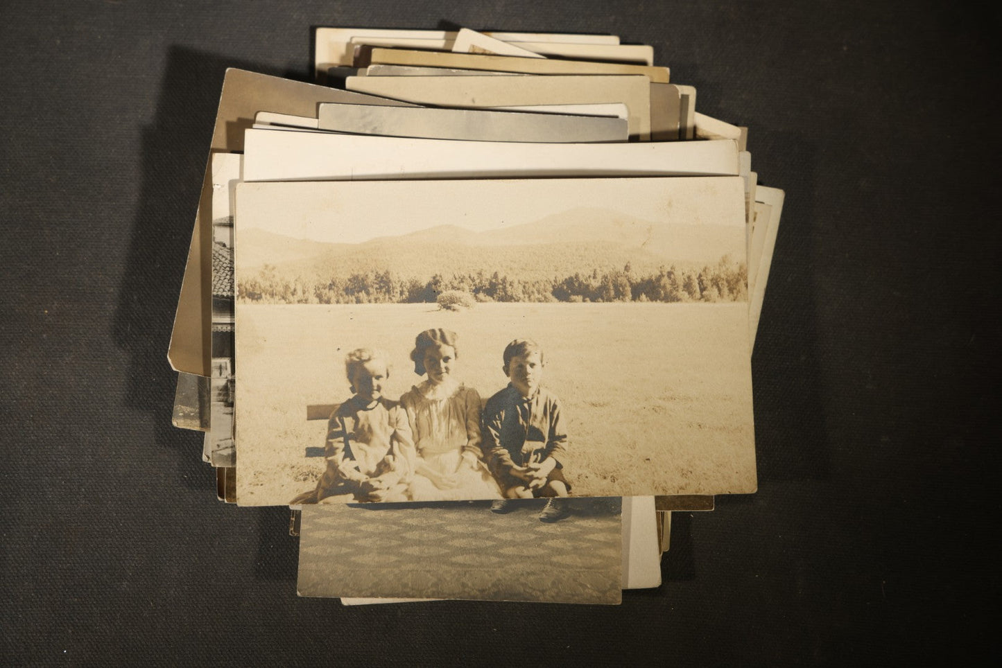 Grouping of approximately 40 Antique Real Photo Postcards R.P.P.C. including Military Soldier Portrait, Ocean Liner, Marching Band, and Portraits