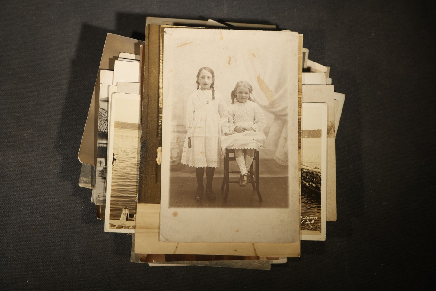 Grouping of approximately 40 Antique Real Photo Postcards R.P.P.C. including Military Soldier Portrait, Ocean Liner, Marching Band, and Portraits