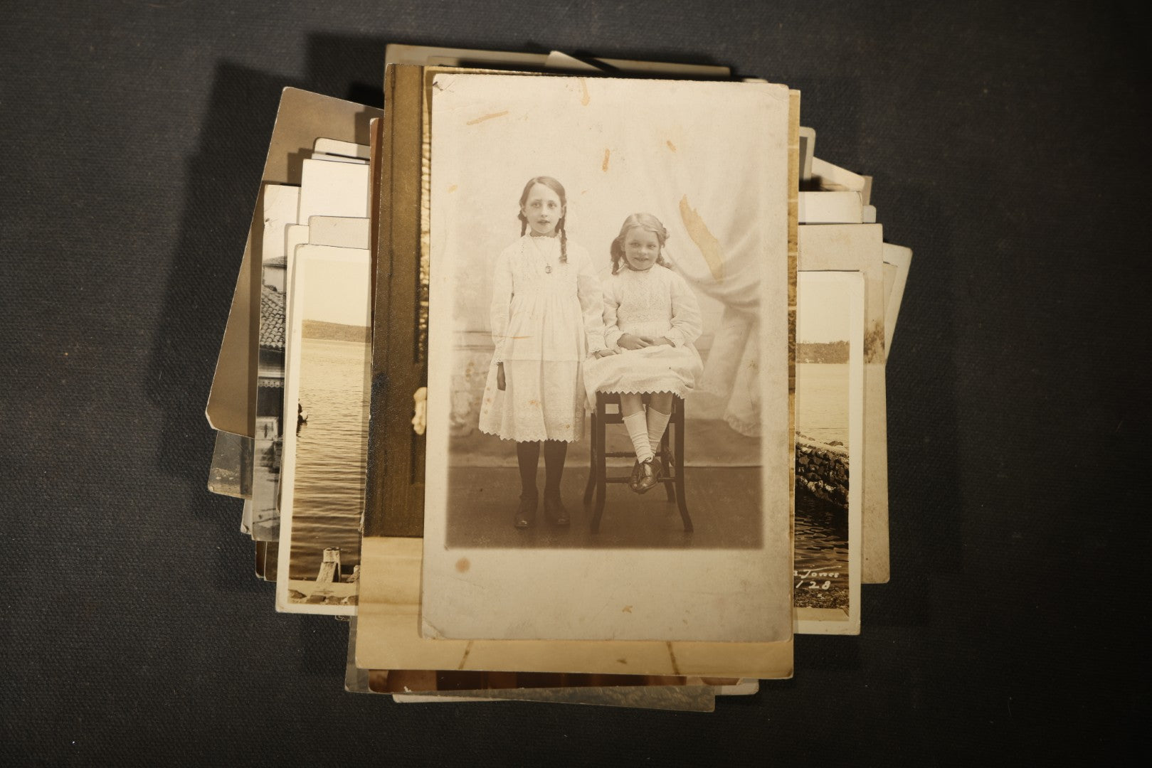 Grouping of approximately 40 Antique Real Photo Postcards R.P.P.C. including Military Soldier Portrait, Ocean Liner, Marching Band, and Portraits