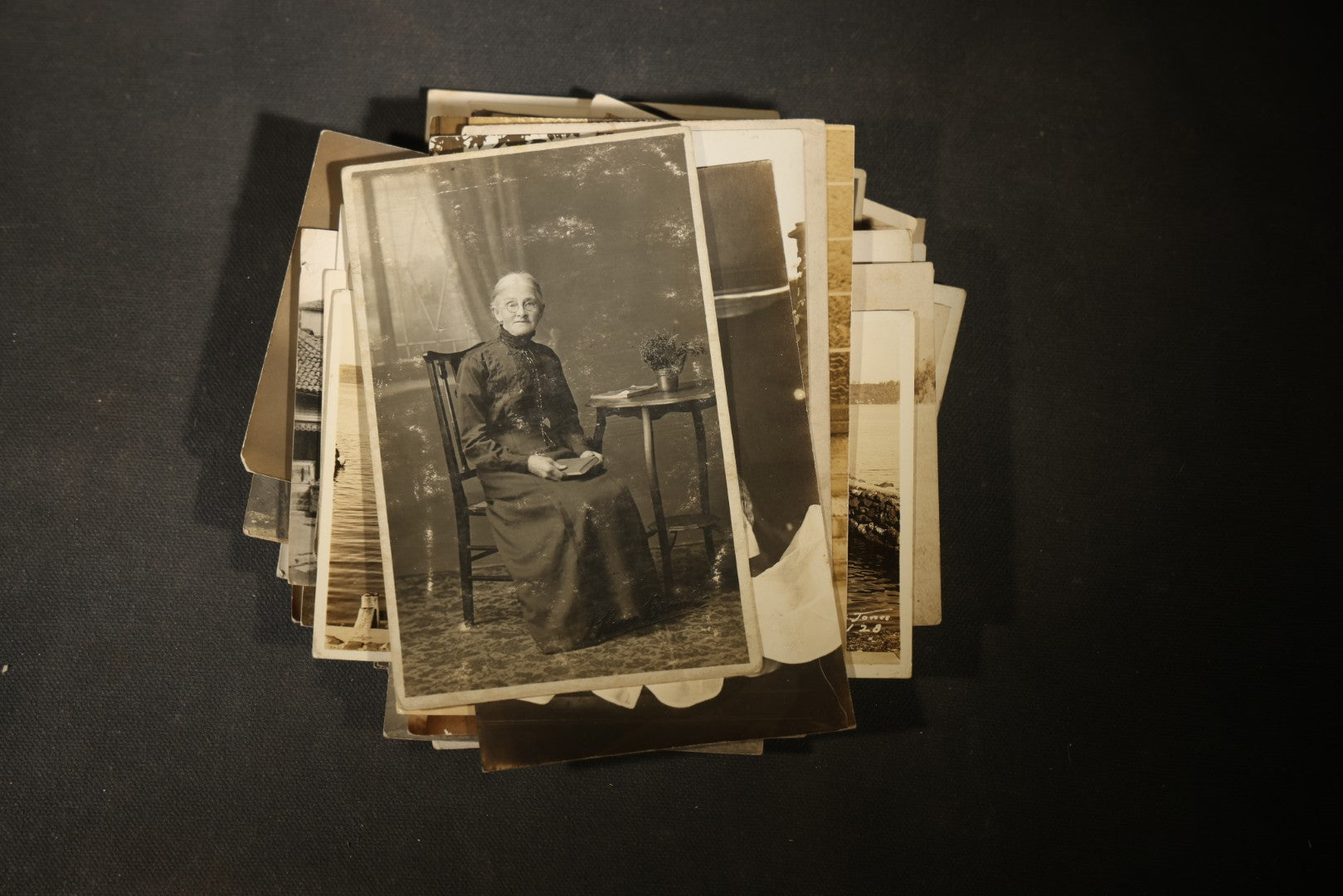 Grouping of approximately 40 Antique Real Photo Postcards R.P.P.C. including Military Soldier Portrait, Ocean Liner, Marching Band, and Portraits
