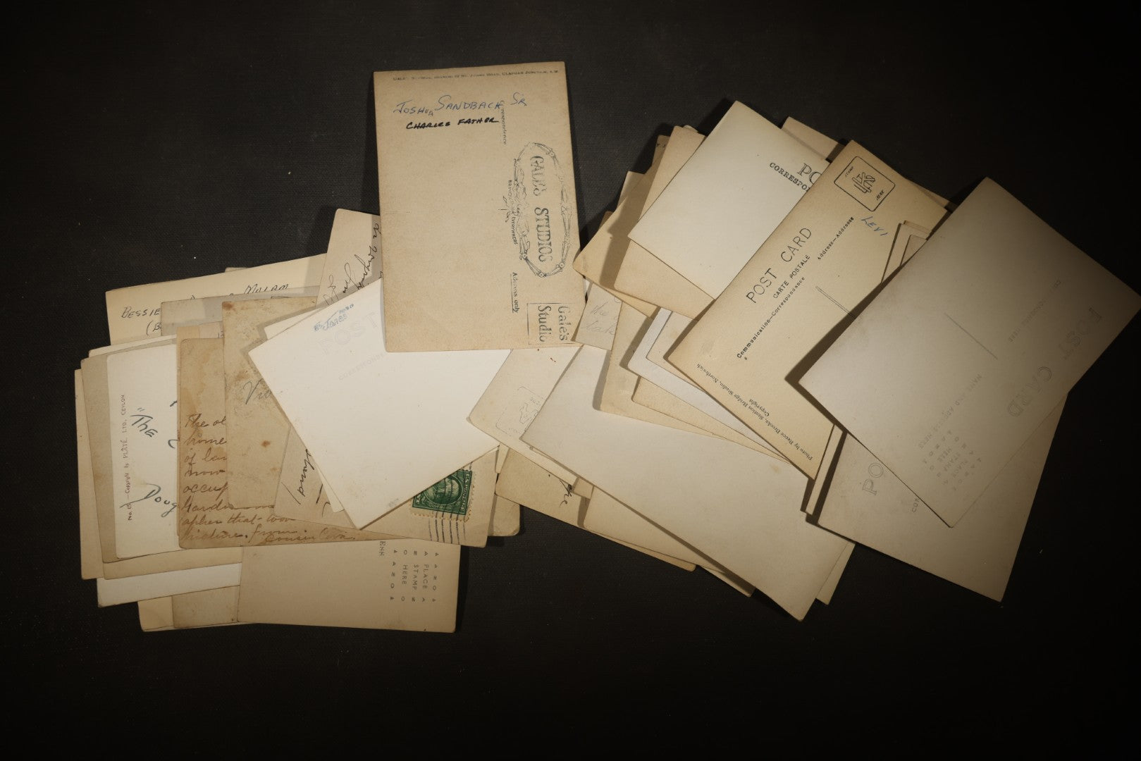 Grouping of approximately 40 Antique Real Photo Postcards R.P.P.C. including Military Soldier Portrait, Ocean Liner, Marching Band, and Portraits