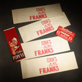 Lot 132 - Grouping of Six Vintage Advertising Ephemera Pieces Including Four Cook's All Meat Hickory-Smoked Franks Hats, Cafes Popeye Bag, and Red Devil Carboloy Blade Package