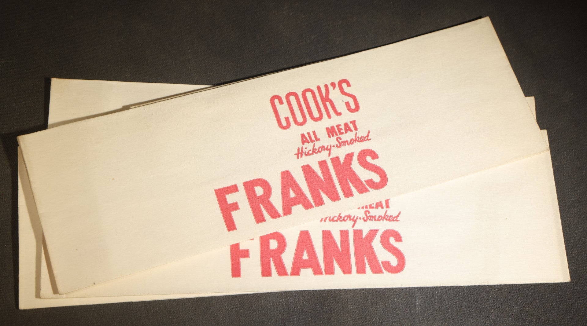 Grouping of Six Vintage Advertising Ephemera Pieces including Four Cook's All Meat Hickory-Smoked Franks Hats, Cafes Popeye Bag, and Red Devil Carboloy Blade Package