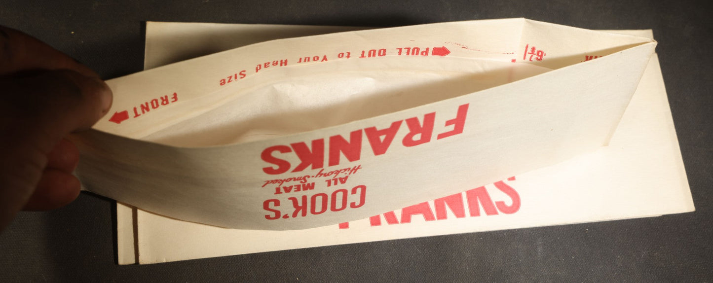 Grouping of Six Vintage Advertising Ephemera Pieces including Four Cook's All Meat Hickory-Smoked Franks Hats, Cafes Popeye Bag, and Red Devil Carboloy Blade Package