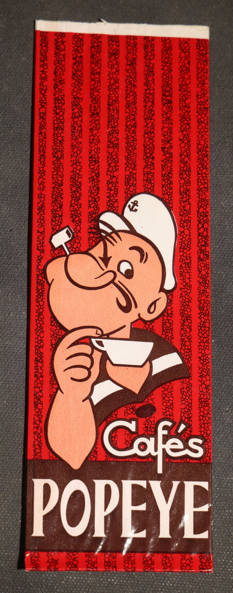 Grouping of Six Vintage Advertising Ephemera Pieces including Four Cook's All Meat Hickory-Smoked Franks Hats, Cafes Popeye Bag, and Red Devil Carboloy Blade Package
