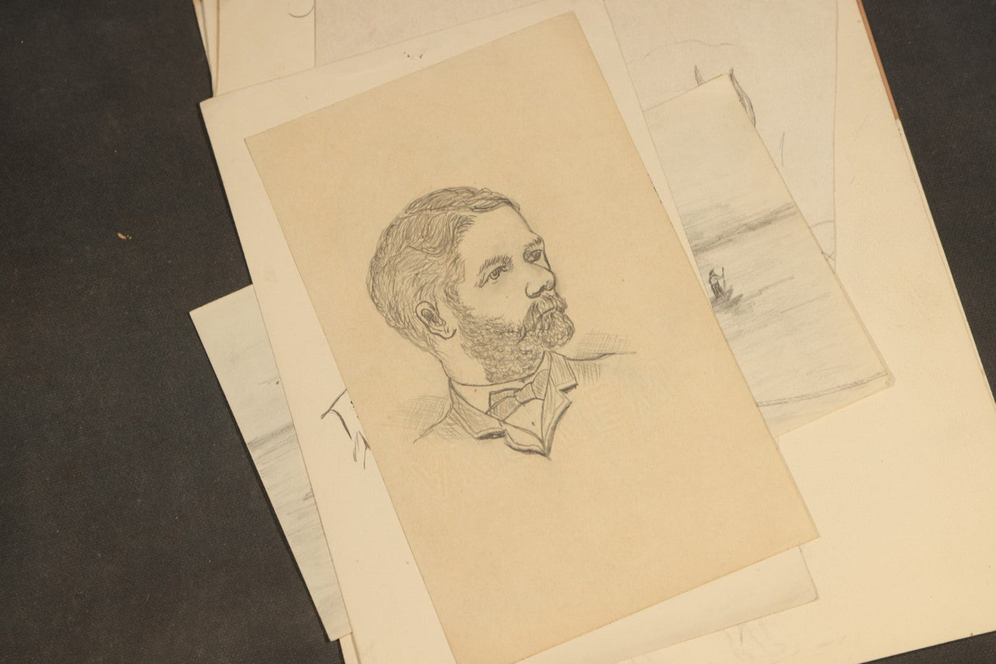 Grouping of 20 Antique Pen and Pencil Sketches including Portraits, Coastal Scene, Goat, Flowers, and "An Old Salt" Pipe Smoker, with Decorative "Sketches" Cover Sheet