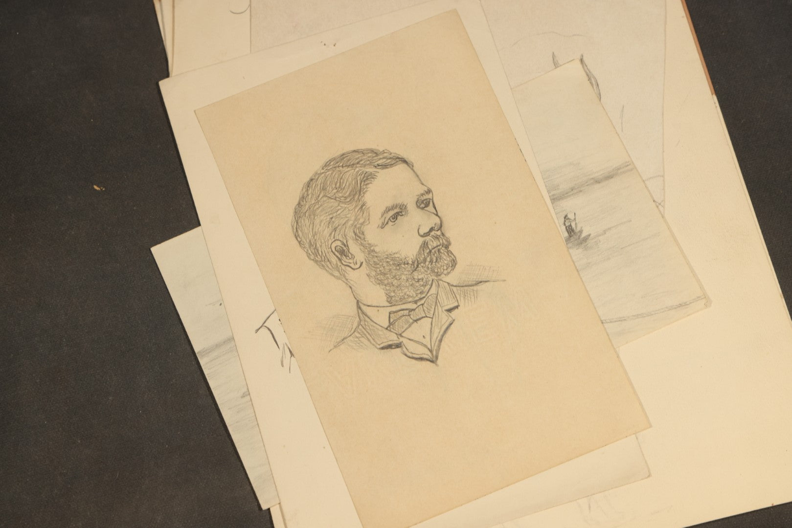 Grouping of 20 Antique Pen and Pencil Sketches including Portraits, Coastal Scene, Goat, Flowers, and "An Old Salt" Pipe Smoker, with Decorative "Sketches" Cover Sheet